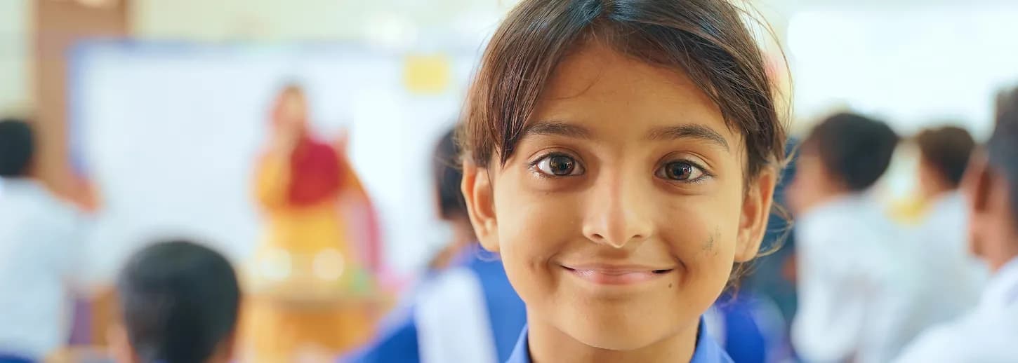 Student sitting in the class smiling