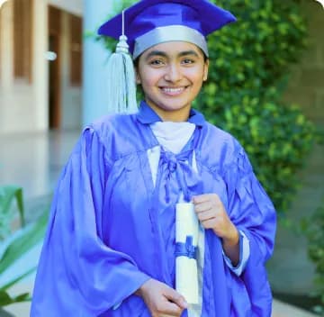 Student Wearing Graduation Gown Writing